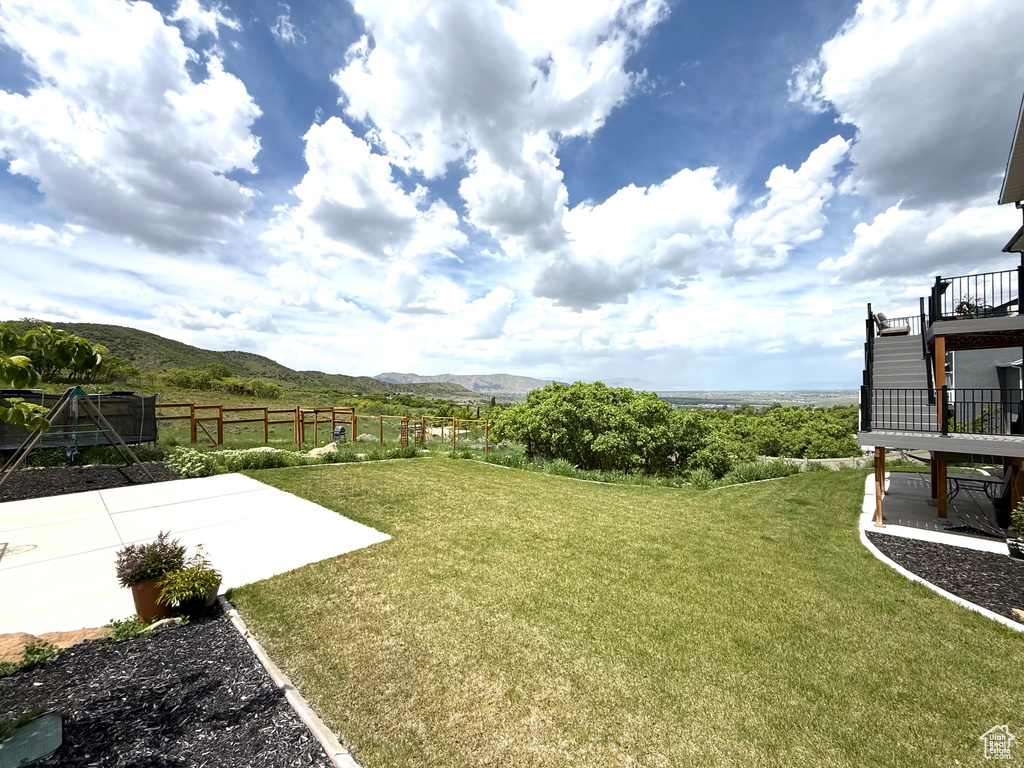 View of yard featuring a mountain view, a patio area, and stairs