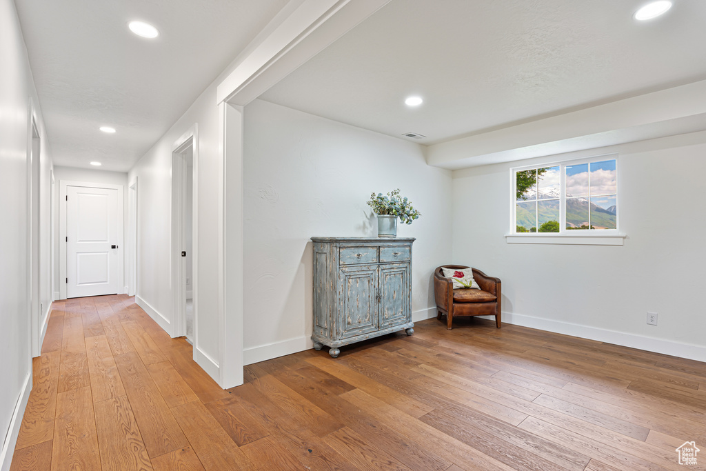 Hall featuring light wood-type flooring, recessed lighting, and baseboards