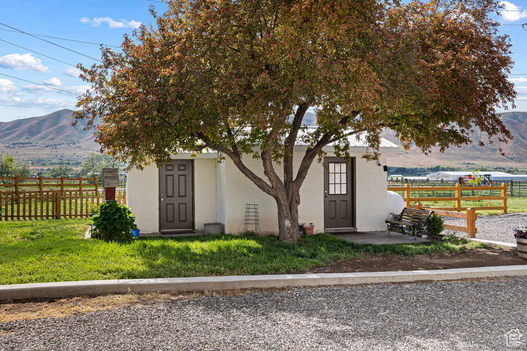 View of front of property featuring a mountain view and concrete block siding