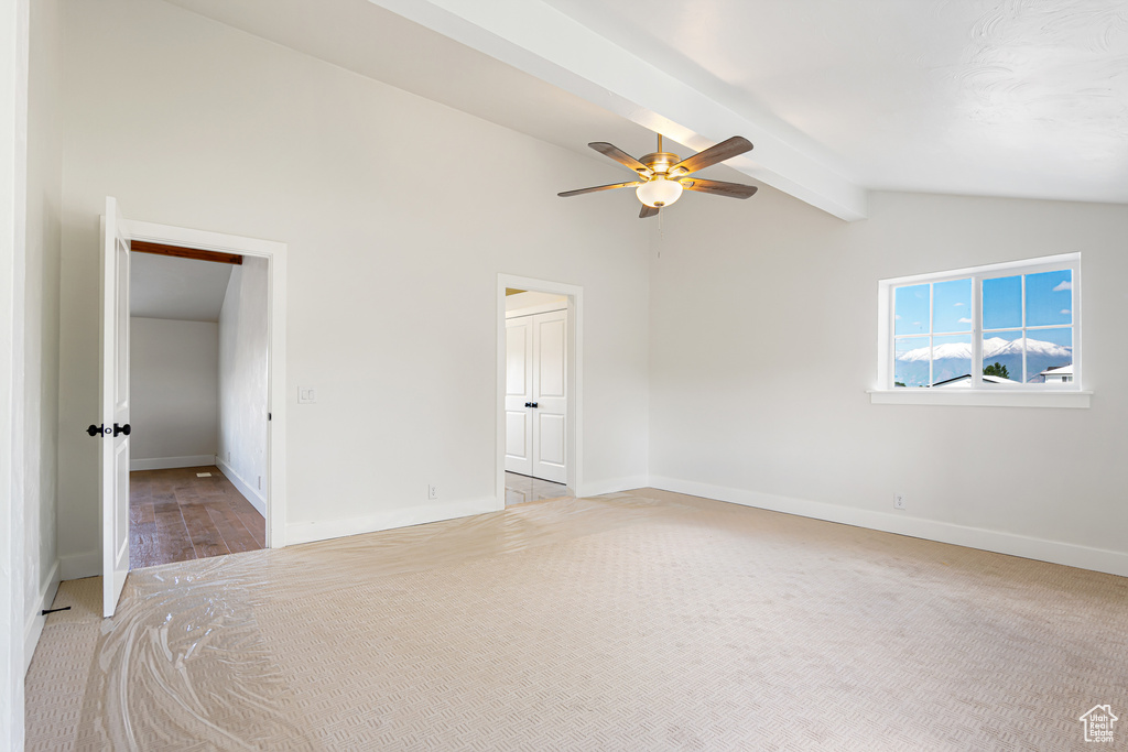 Unfurnished bedroom featuring baseboards, light colored carpet, and ceiling fan