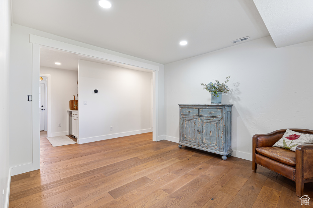 Sitting room featuring light wood-style floors, recessed lighting, and baseboards