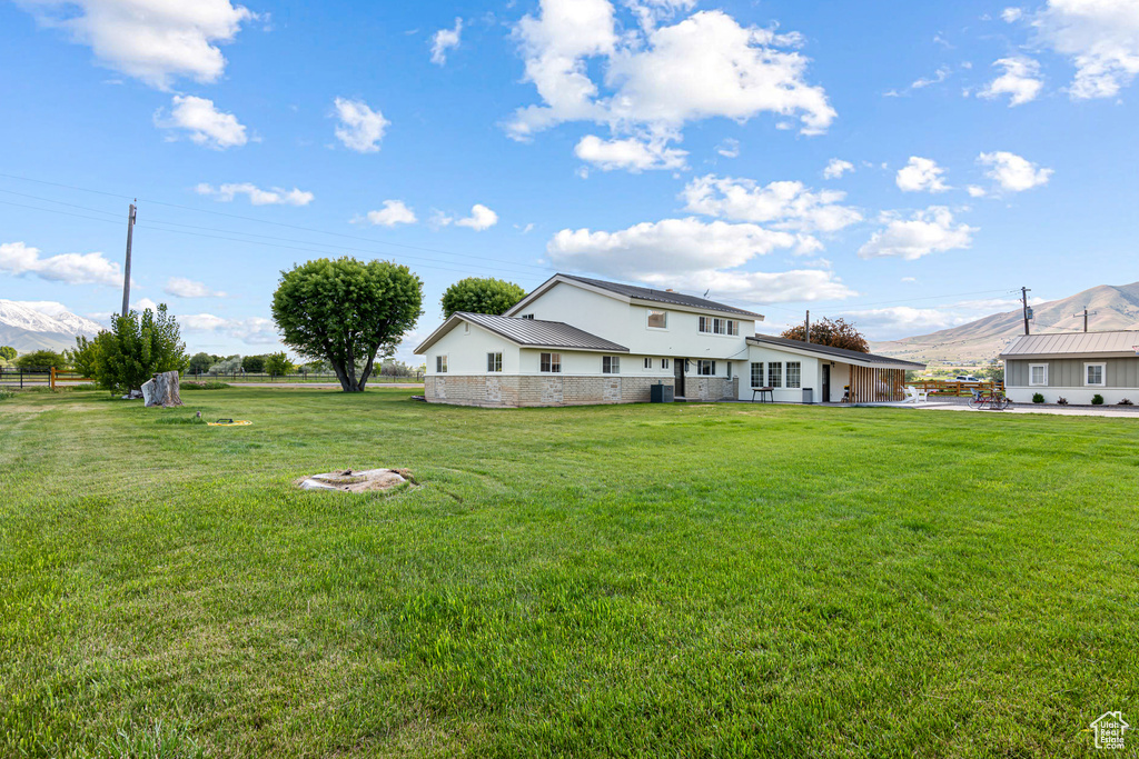 View of grassy yard with a mountain view