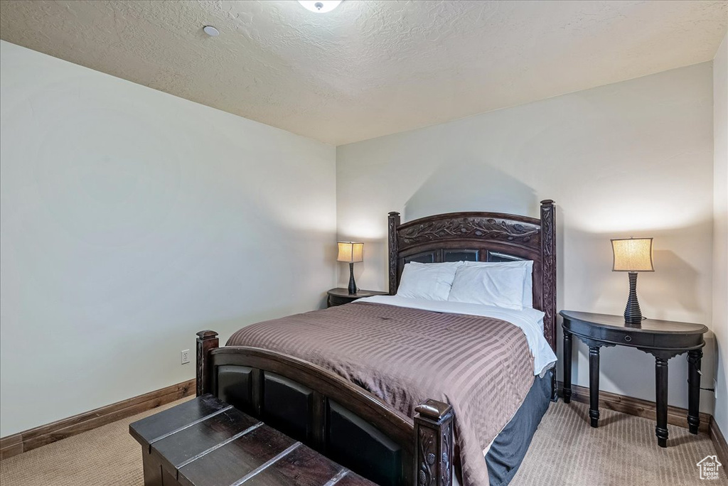 Bedroom with baseboards and carpet flooring