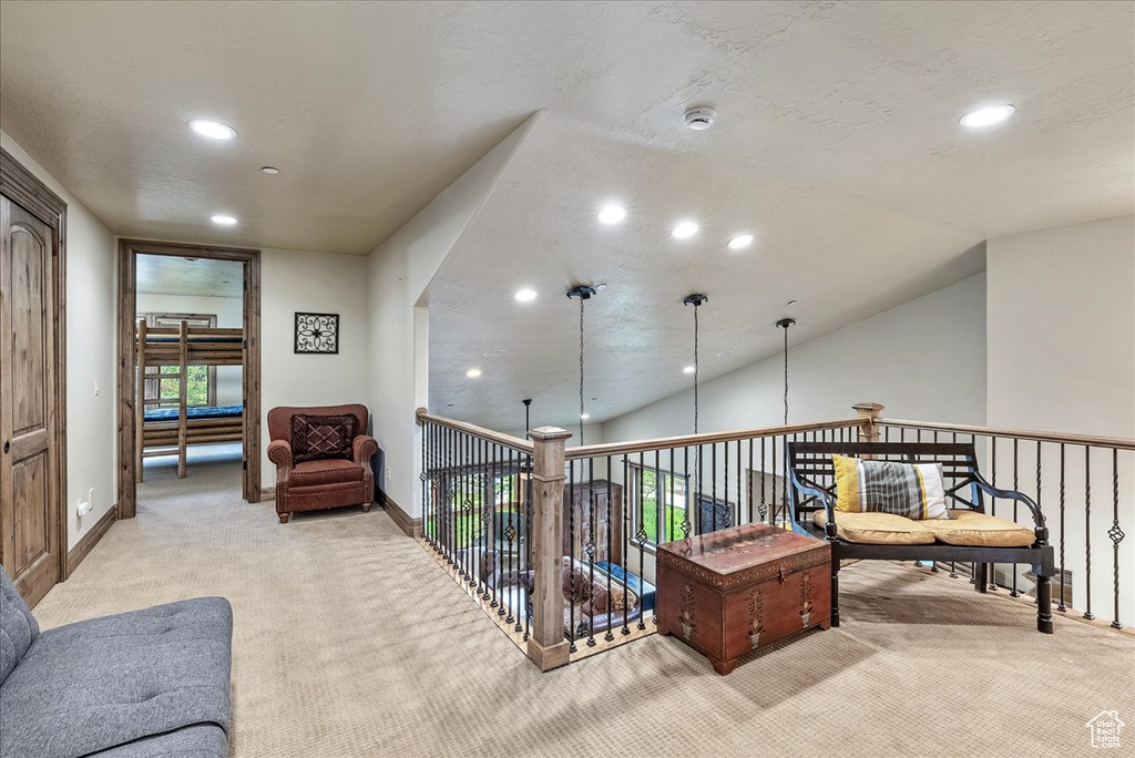 Living area with light carpet, recessed lighting, baseboards, and lofted ceiling