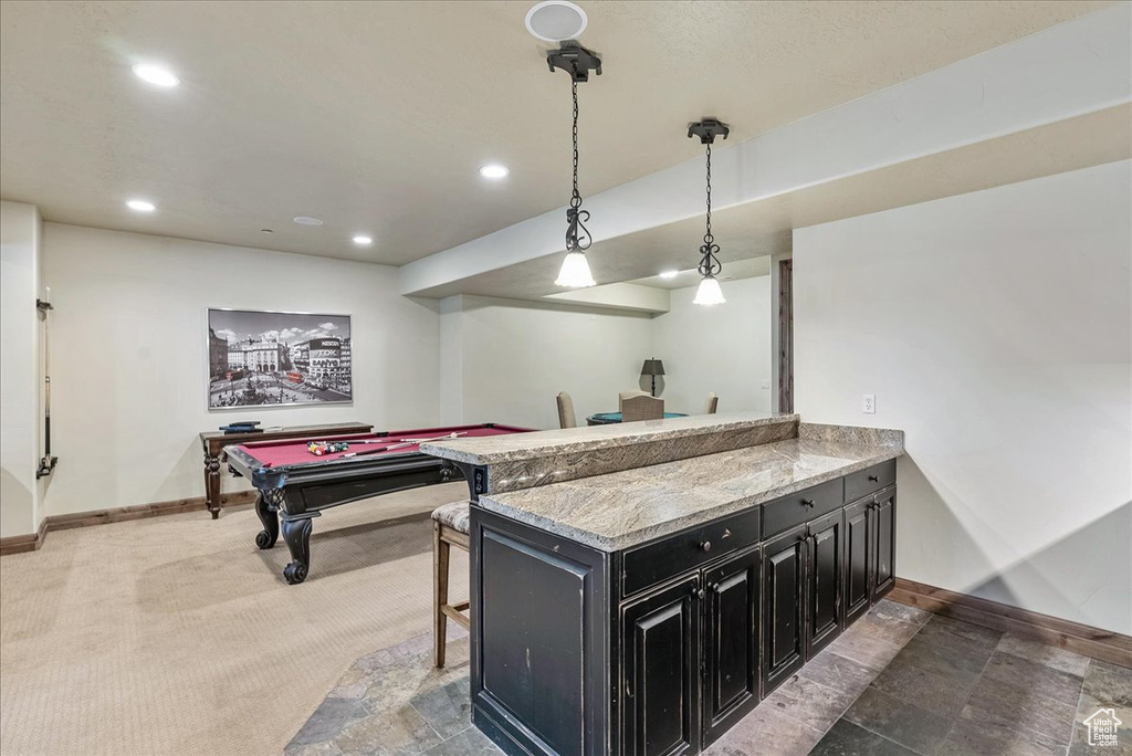 Kitchen with dark cabinetry, baseboards, pendant lighting, billiards table, and recessed lighting