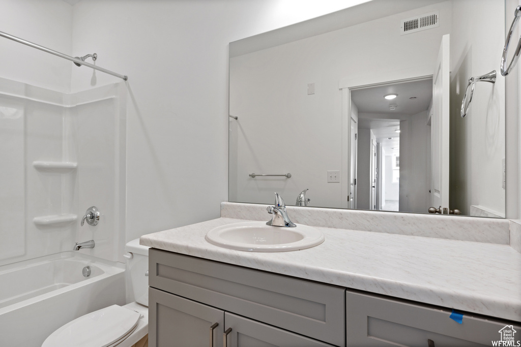 Full bath featuring visible vents, tub / shower combination, vanity, and toilet
