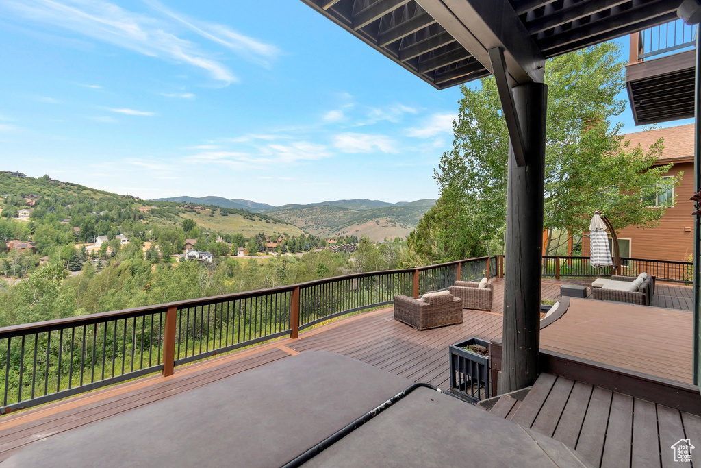 Wooden terrace with a mountain view and an outdoor hangout area