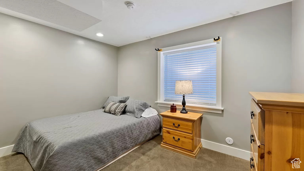Carpeted bedroom featuring recessed lighting and baseboards