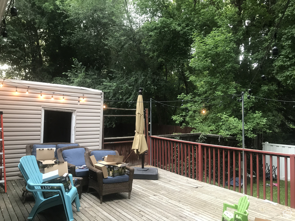 Wooden terrace with fence and outdoor lounge area