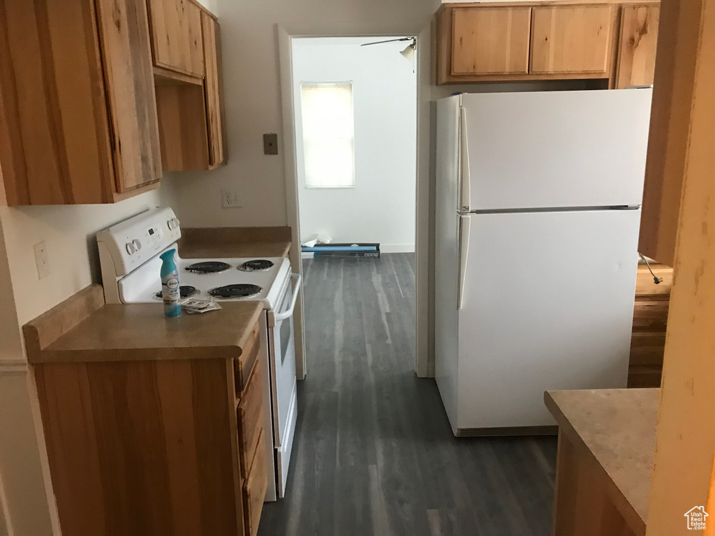 Kitchen with a ceiling fan, white appliances, and dark wood-style floors