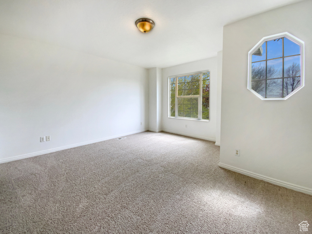 Carpeted empty room with baseboards