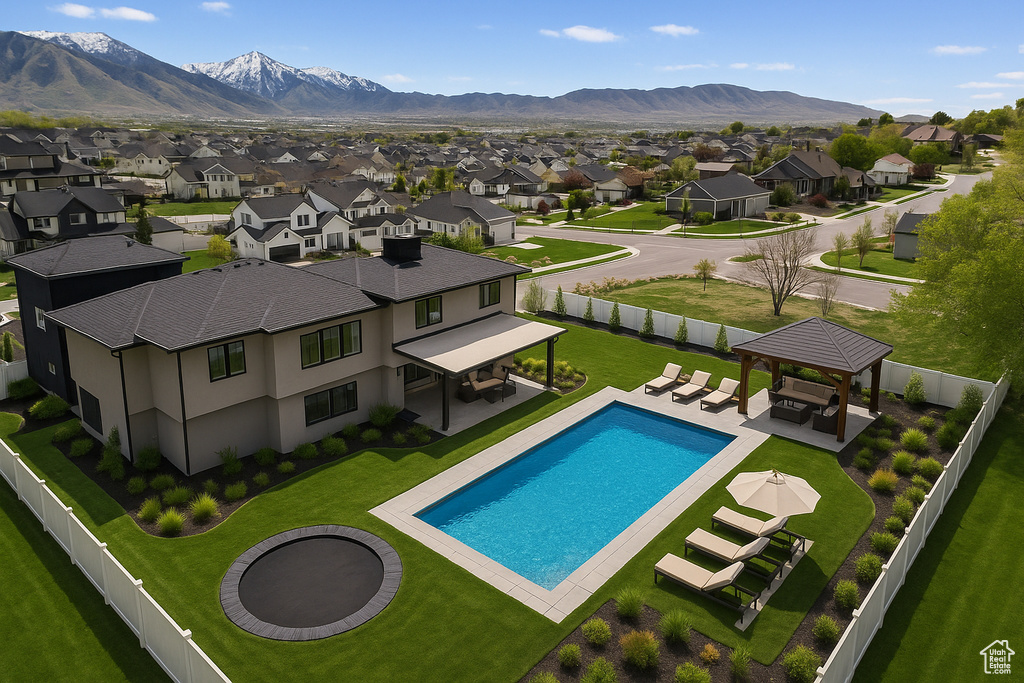 View of pool featuring a gazebo, a residential view, a patio, and a mountain view