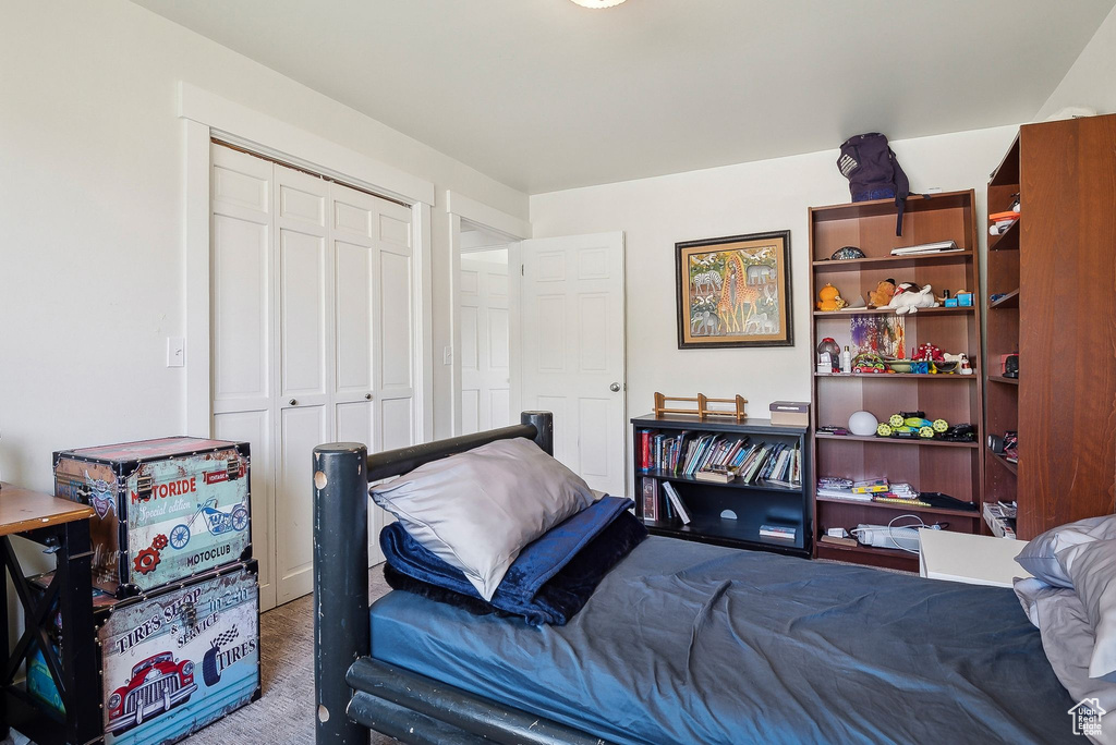 Bedroom with carpet and a closet