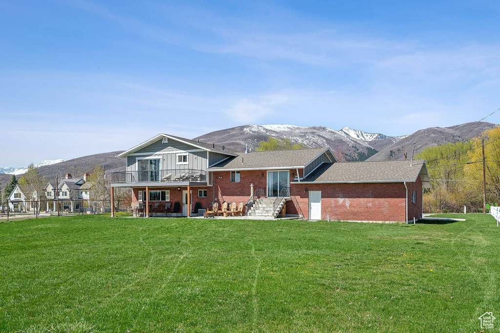 Back of property with brick siding and a mountain view