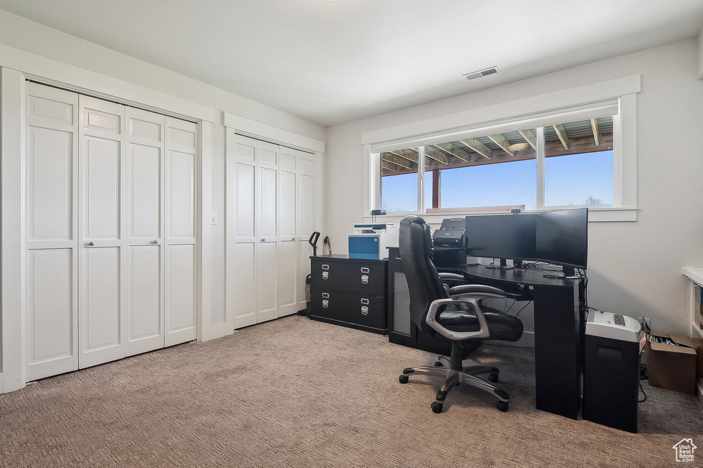 Office with carpet flooring and visible vents