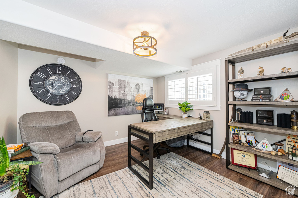 Home office featuring wood finished floors and baseboards