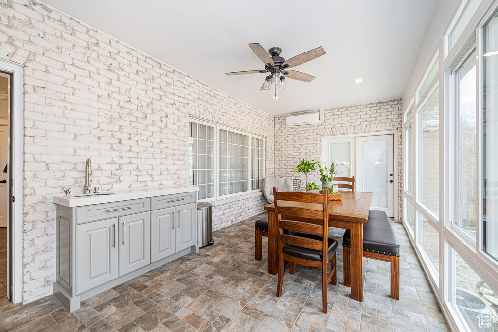 Dining room with recessed lighting, brick wall, an AC wall unit, and ceiling fan