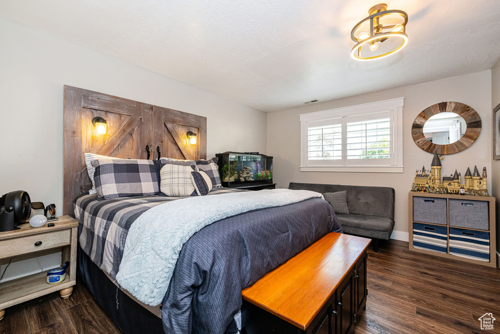 Bedroom featuring baseboards and dark wood-style floors