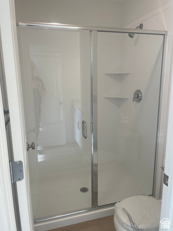 Bathroom with a shower stall and toilet