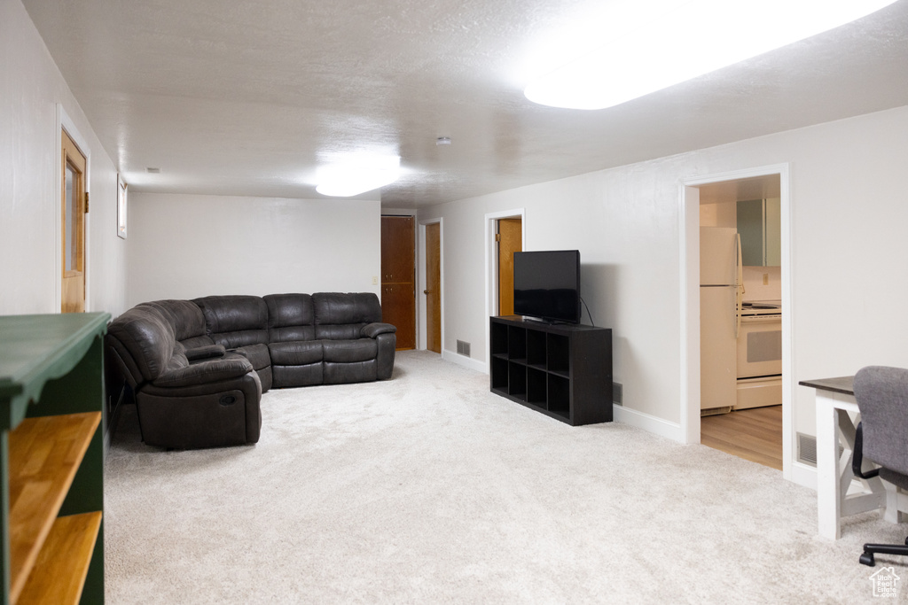 Carpeted living area featuring visible vents