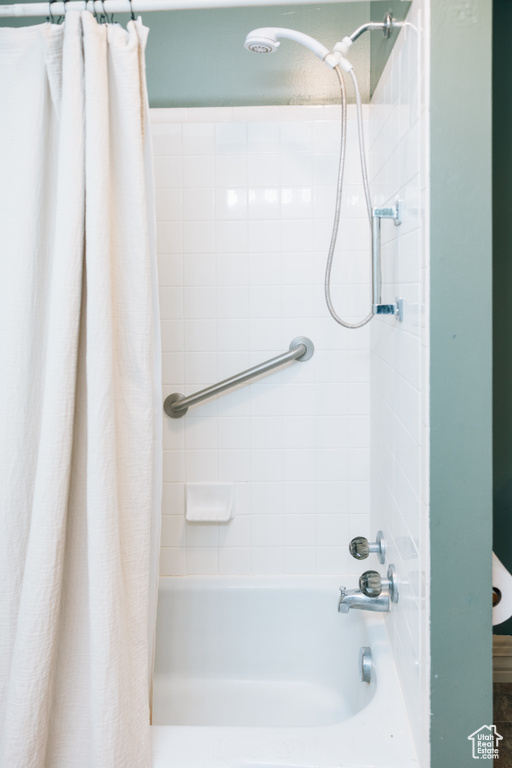 Bathroom featuring shower / bathtub combination with curtain