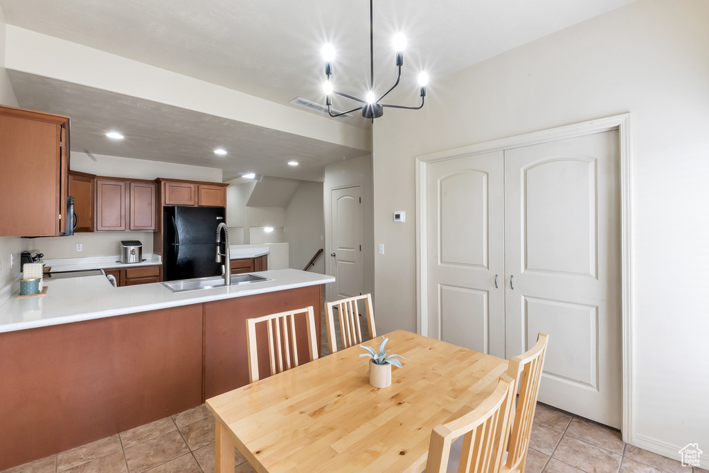 Dining room with an inviting chandelier, recessed lighting, and light tile patterned flooring