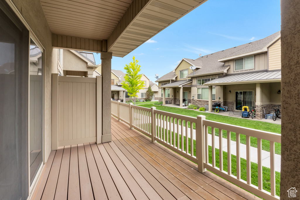 Wooden deck with a residential view and a lawn