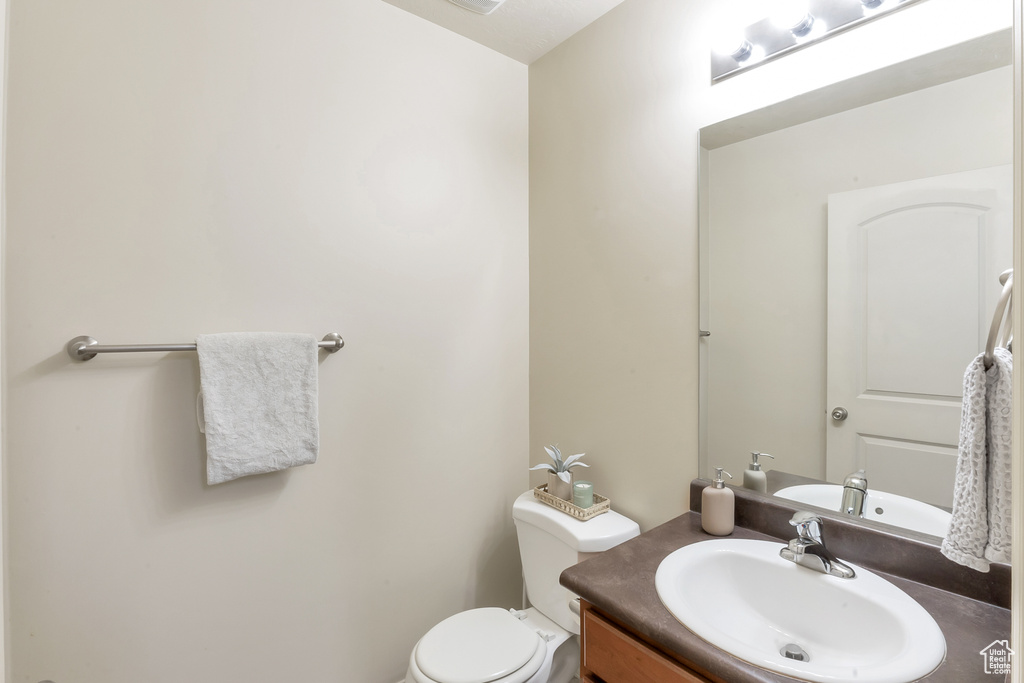 Bathroom featuring vanity and toilet