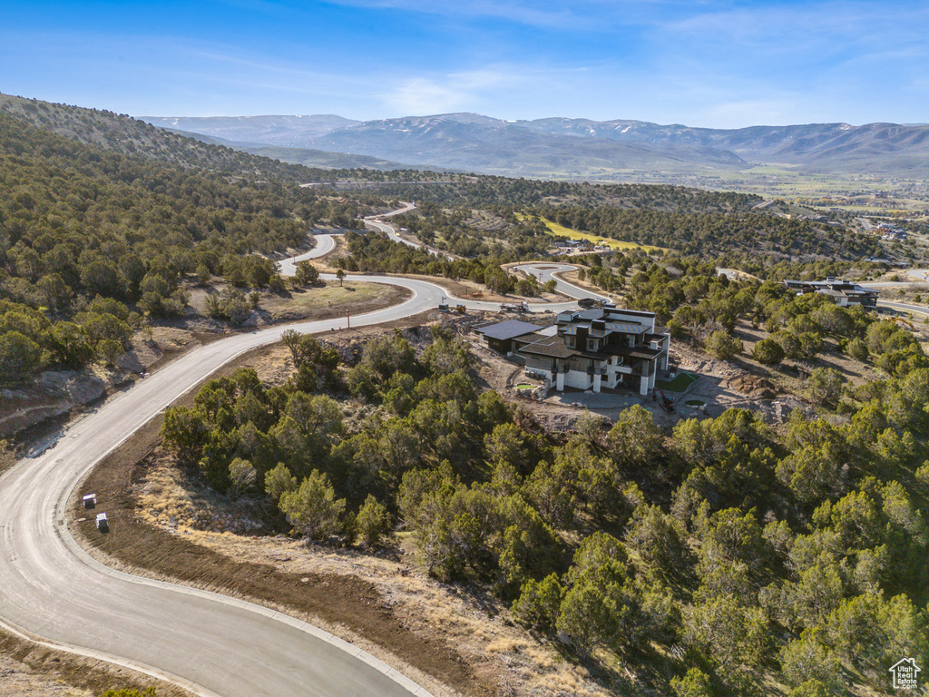 Aerial view of property and surrounding area with a mountainous background
