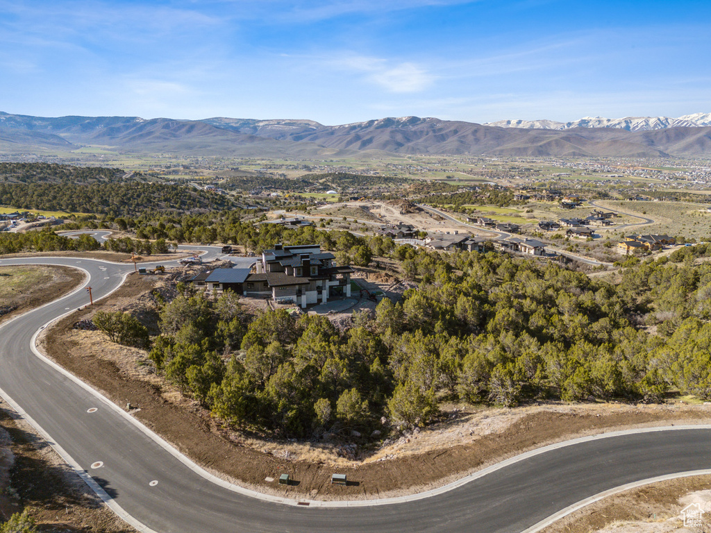 Aerial view of property and surrounding area with mountains
