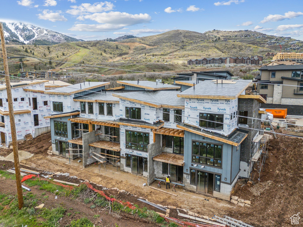 Back of property with a mountain view