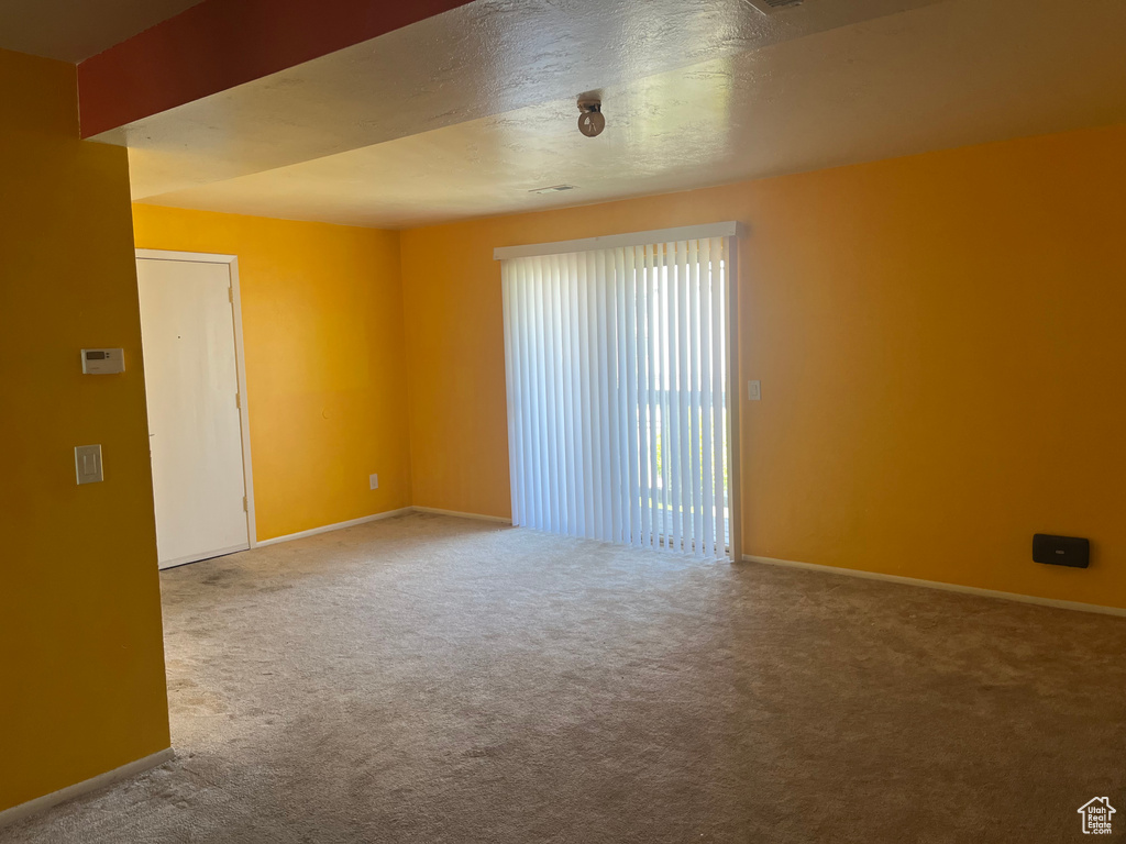 Unfurnished room with baseboards and carpet