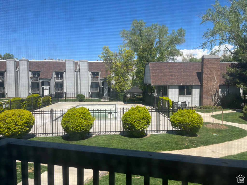 View of community featuring fence