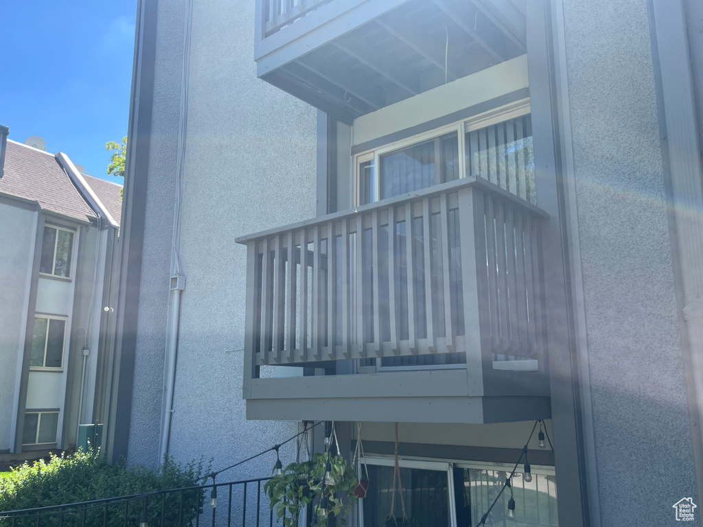 Exterior space featuring fence and stucco siding