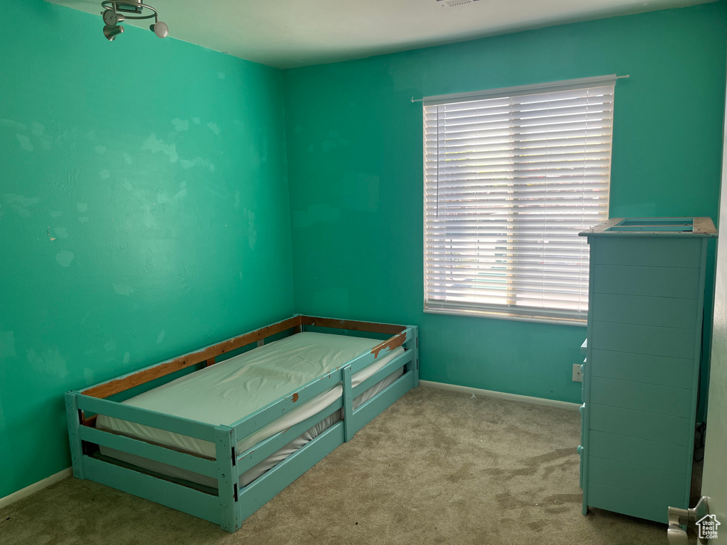 Carpeted bedroom with baseboards