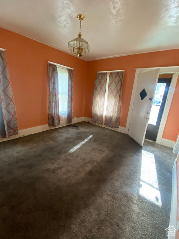 Carpeted empty room featuring baseboards