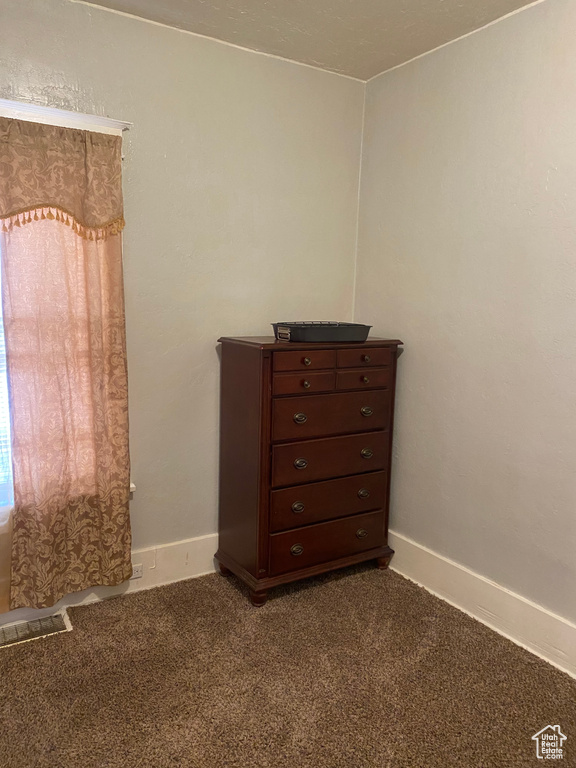 Room details with carpet flooring and baseboards