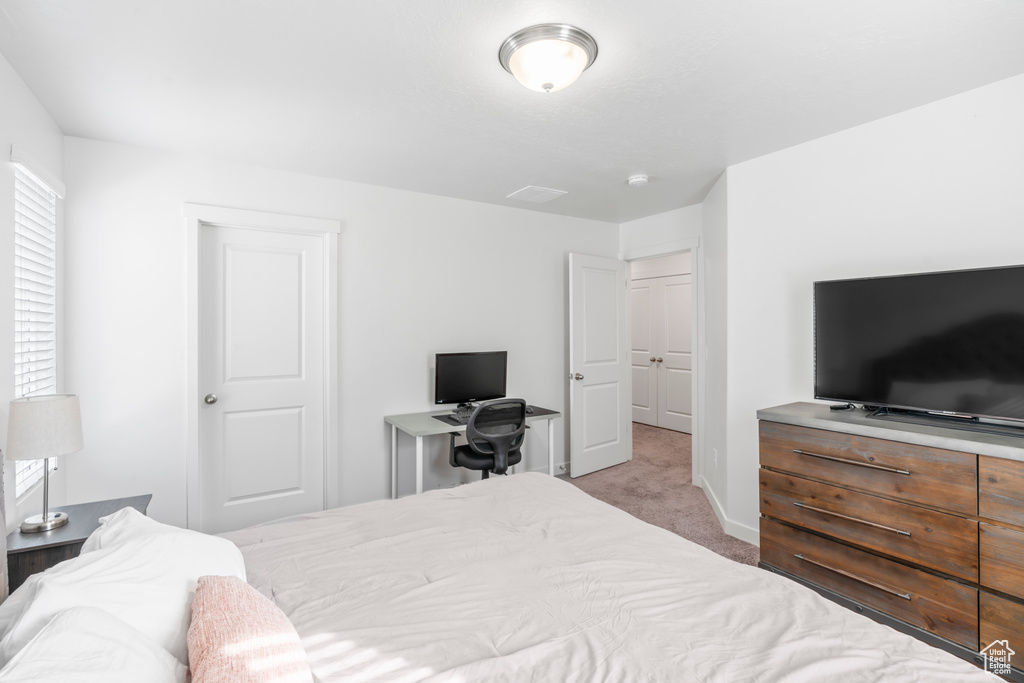 Carpeted bedroom featuring baseboards