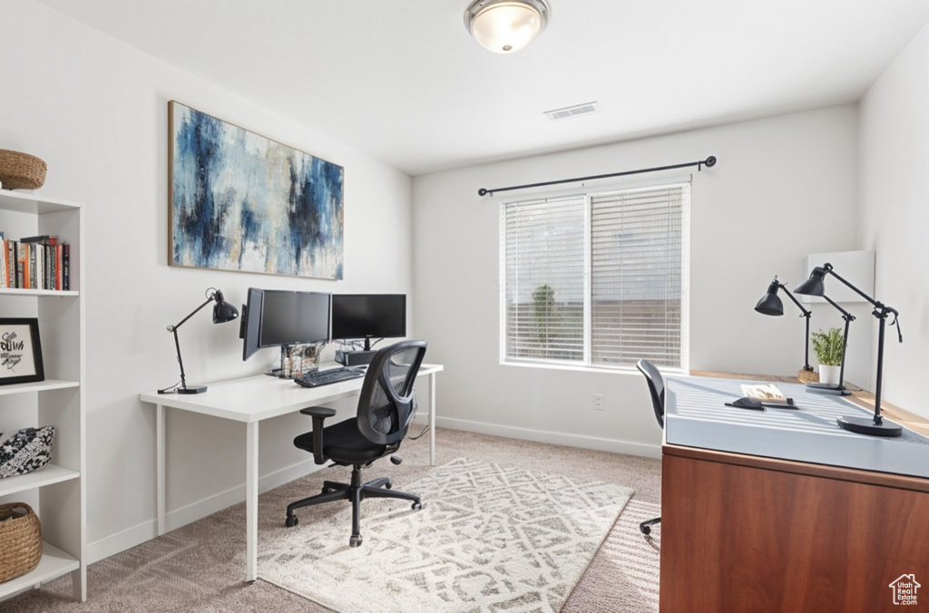Office featuring light carpet and baseboards