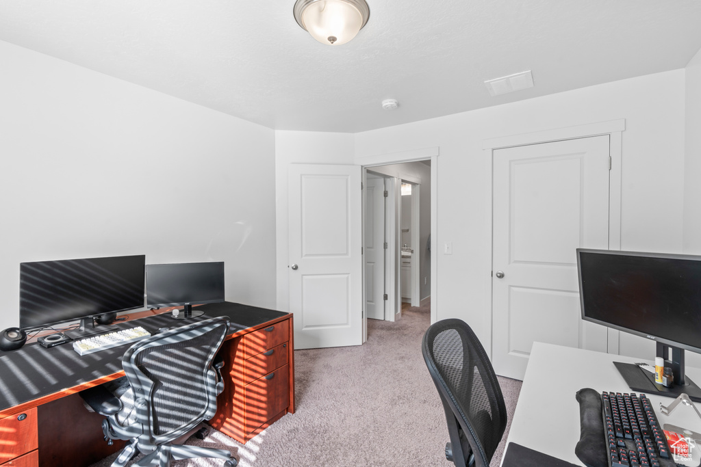 Carpeted office featuring visible vents