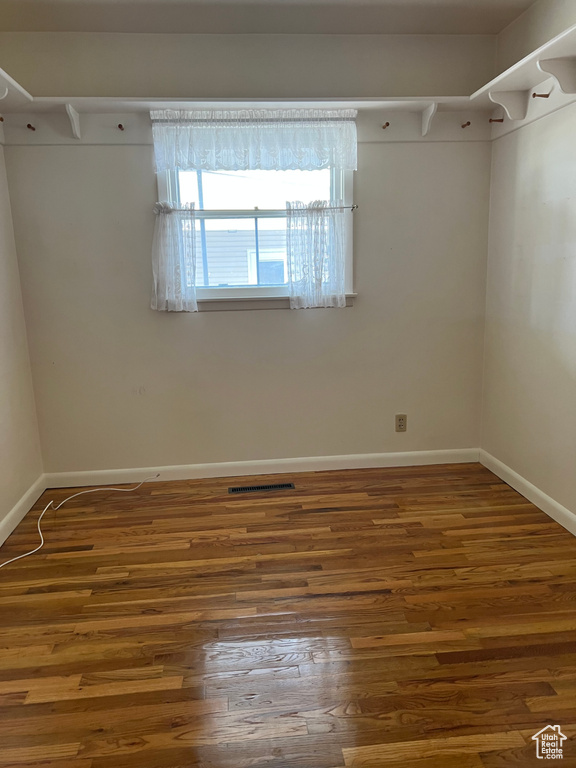 Spacious closet with wood finished floors and visible vents