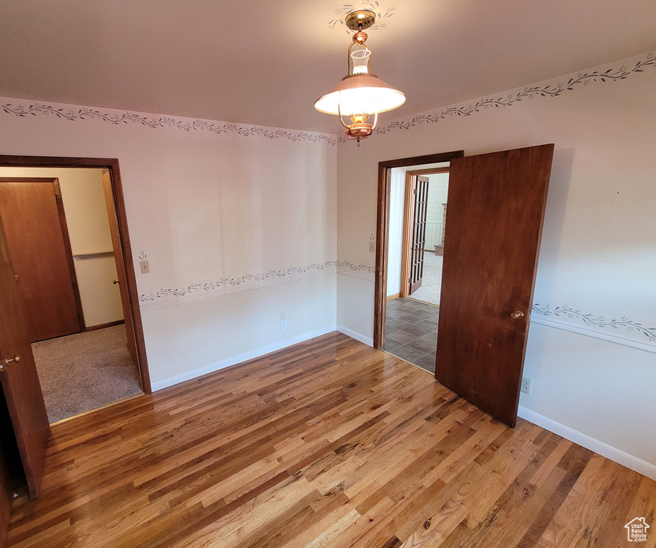 Unfurnished room featuring light wood finished floors and baseboards
