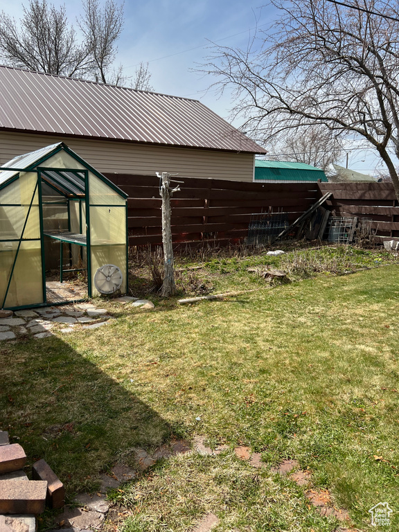 View of yard with an exterior structure and an outdoor structure