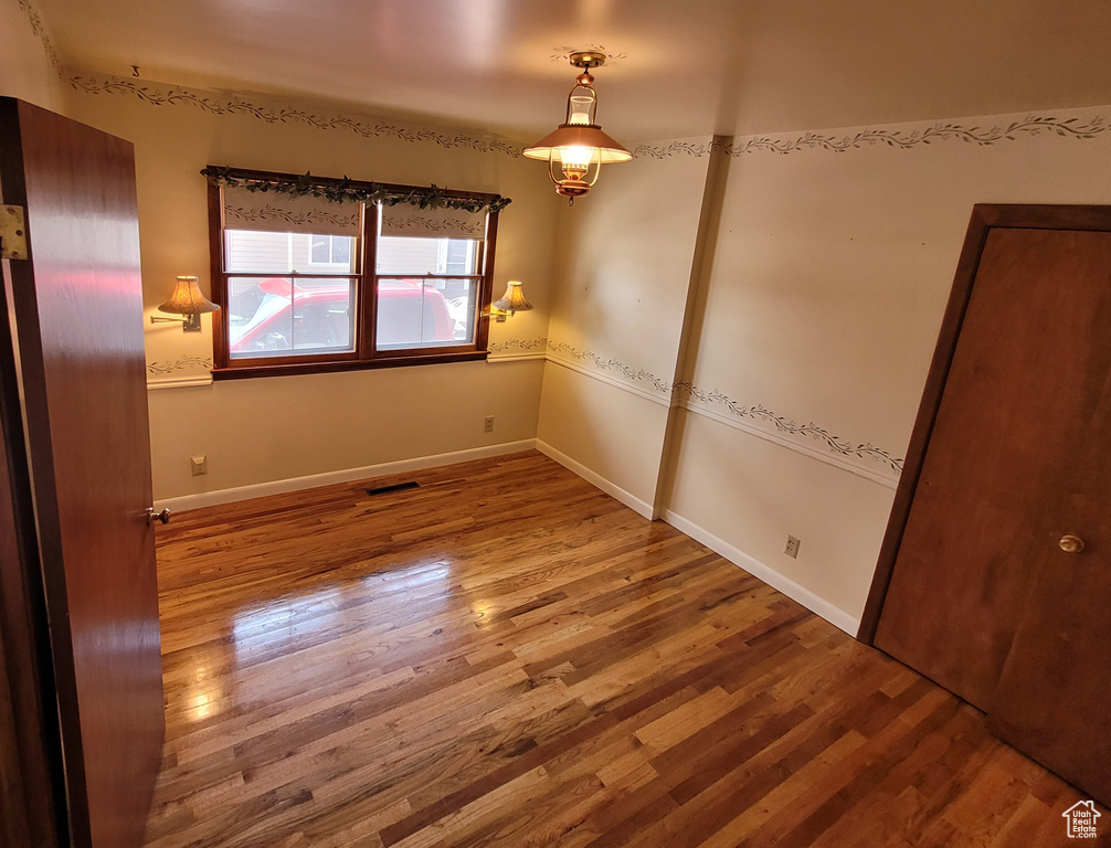 Empty room with wood finished floors and baseboards