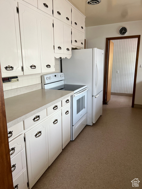 Kitchen with visible vents, backsplash, white cabinetry, light countertops, and white range with electric cooktop