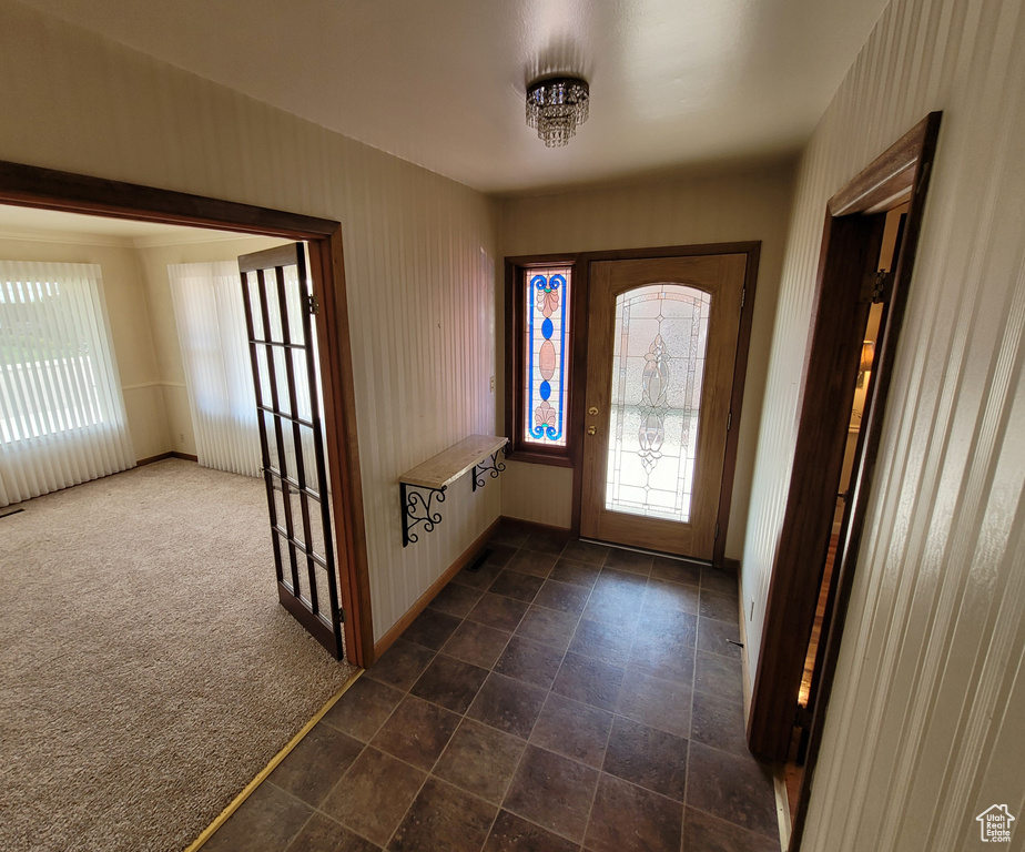 Entryway featuring dark carpet