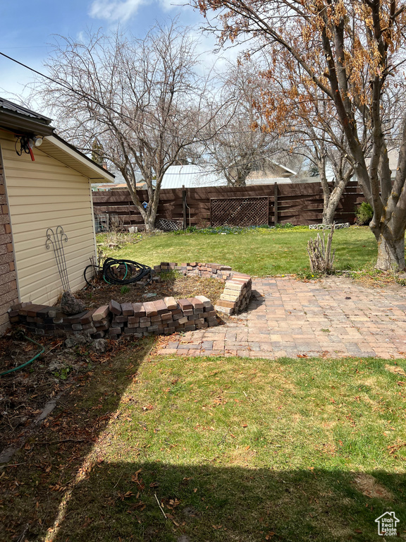 View of yard with a fenced backyard and a patio