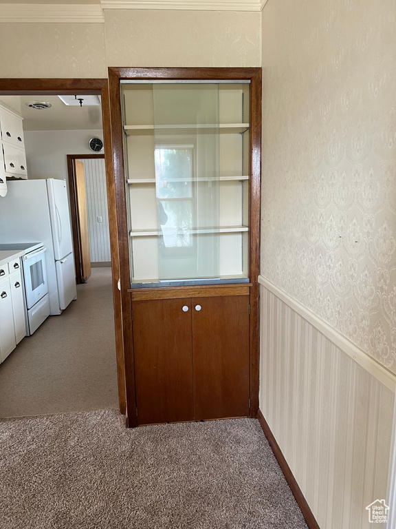 Unfurnished dining area featuring visible vents and light colored carpet