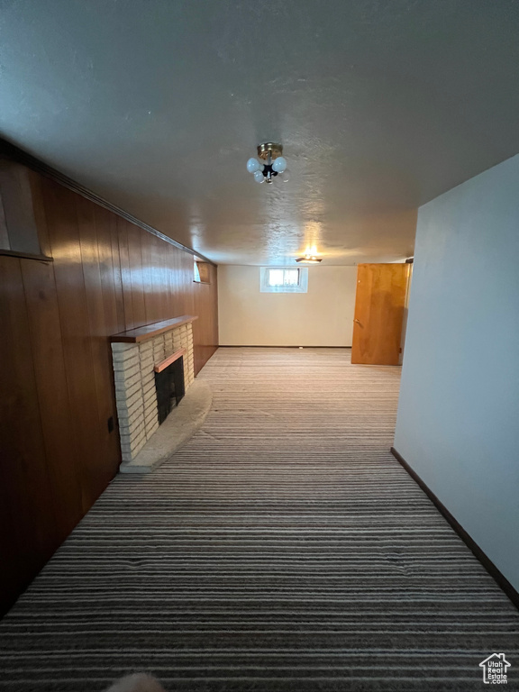 Corridor featuring carpet floors and wood walls