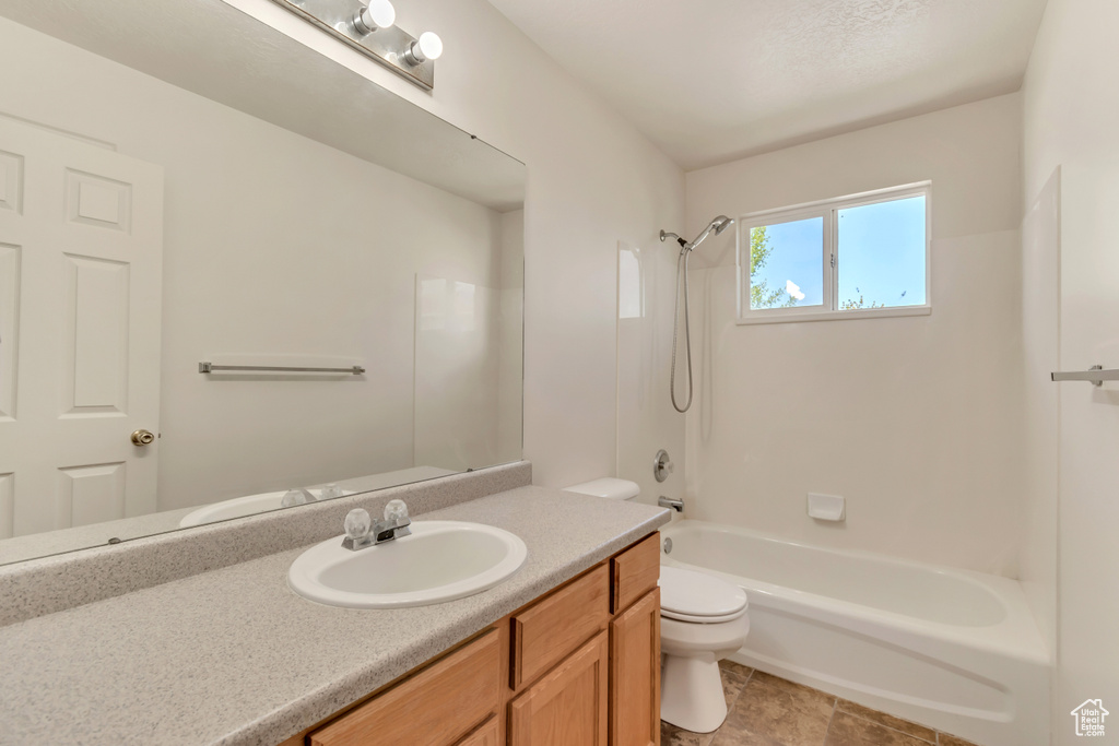 Full bathroom featuring toilet, vanity, and shower / bathing tub combination